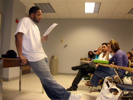 Greg Carter reads a sample of his work to students from Professor David Coogan’s writing workshop at the Richmond Jail. Photo provided by David Coogan.