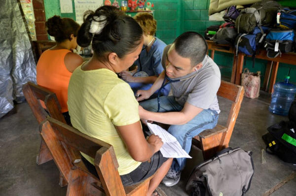 Jeff Wang, M.D., (medicine third-year resident, VCU School of Medicine graduate) examines a patient in La Hicaca. Photos courtesy of the Global Health and Health Disparities Program. 