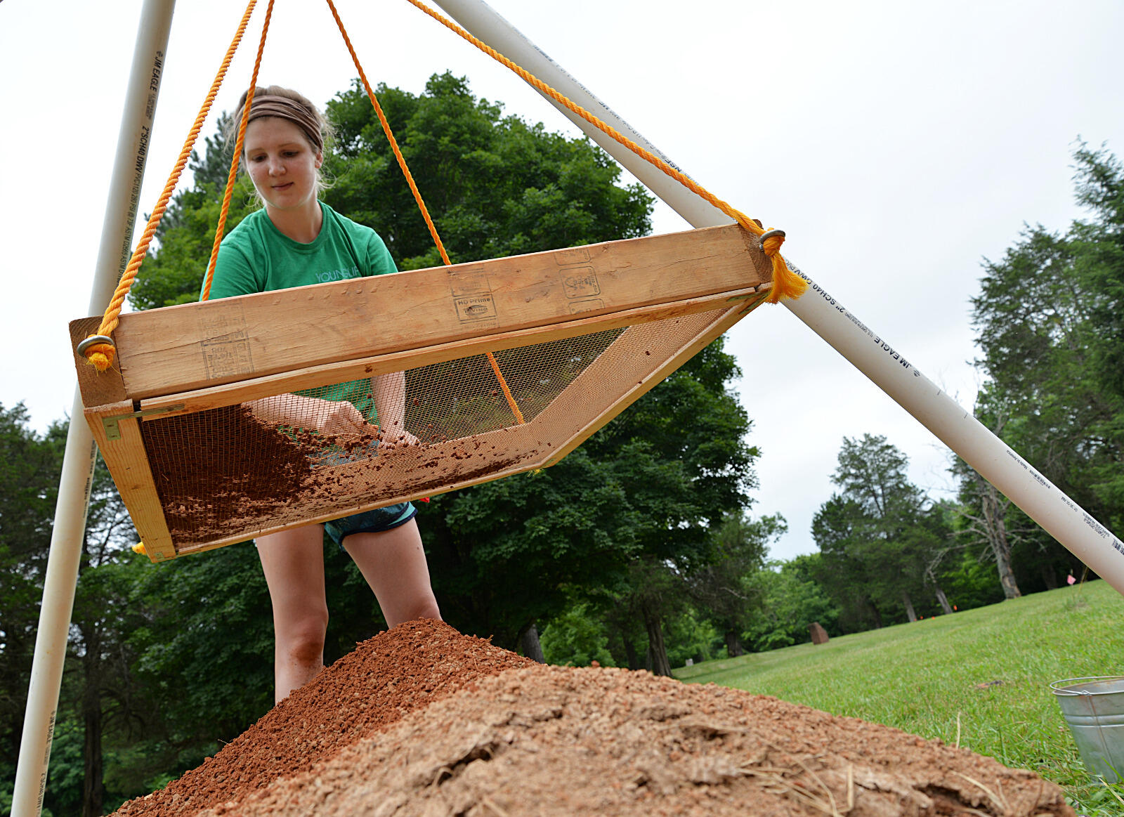 Zoe Rahsman, a VCU anthropology major who graduated in December, sifts through dirt at the Fort Germanna/Enchanted Castle site, searching for artifacts.