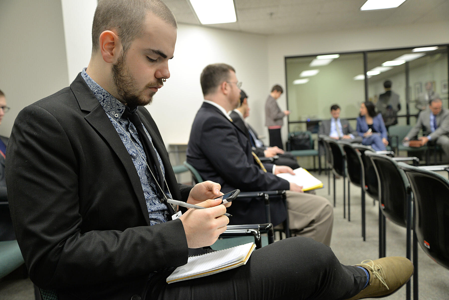 Senior journalism major Tyler Hammel covers a Virginia Senate subcommittee as it debates legislation that would keep chemical recipes used in fracking confidential as trade secrets.
<br>Photo by Brian McNeill, University Public Affairs