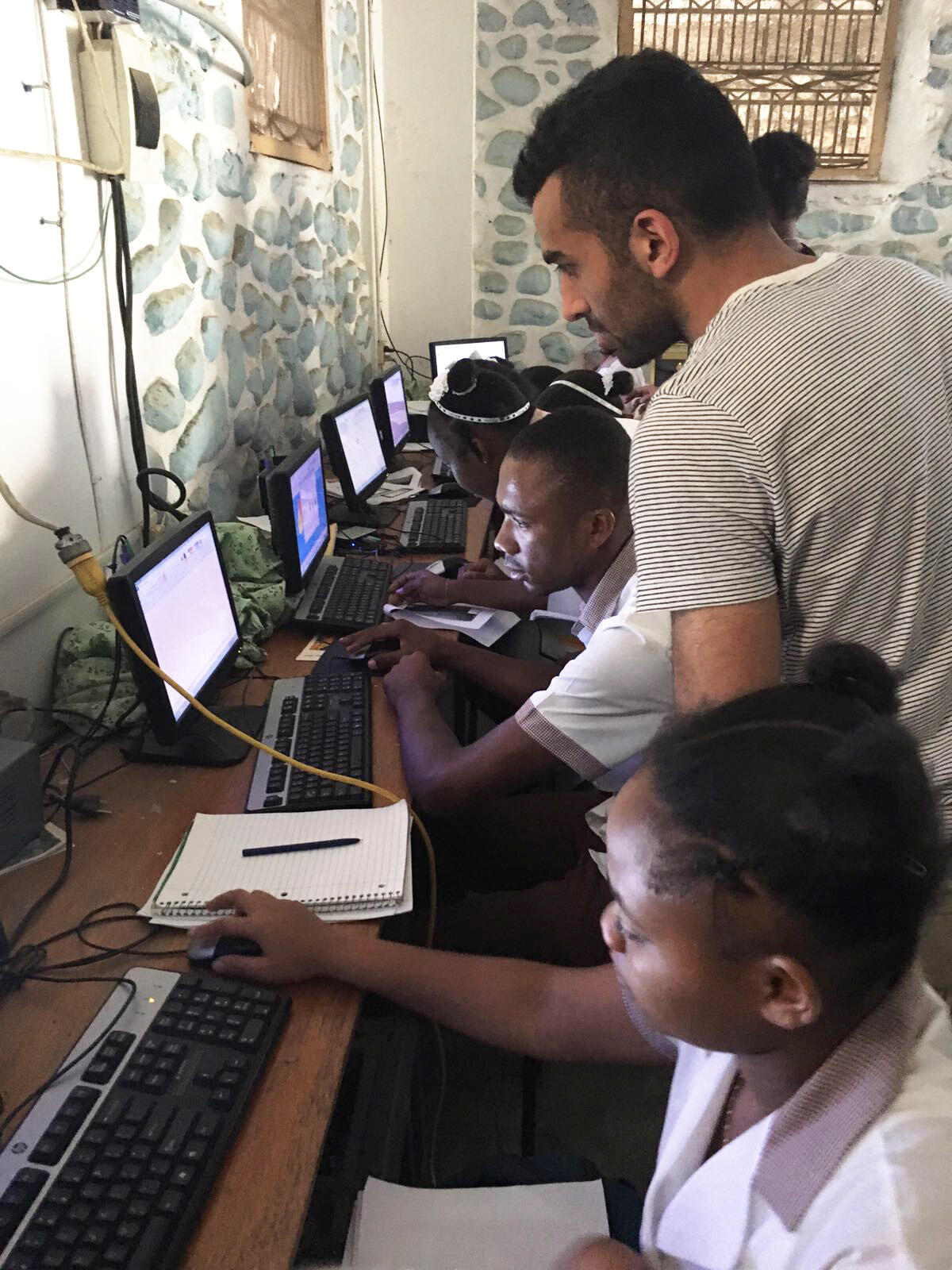 Nabeel Janjua teaches computer skills to students in Haiti.