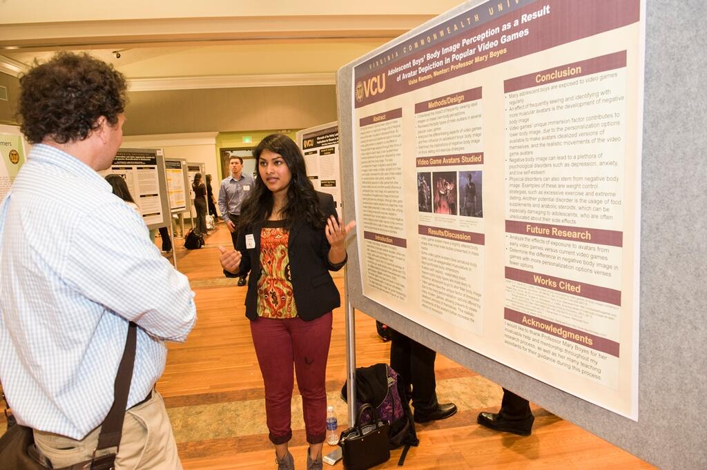 Freshman Usha Raman presents her research at the Poster Symposium for Undergraduate Research and Creativity. Raman studied the impact of video game avatars on body image in adolescent boys. Photo by Tom Kojcsich, University Marketing.