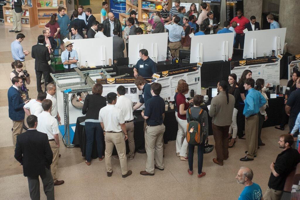 Visitors explore the variety of projects on display at the Science Museum of Virginia during the 2015 School of Engineering Capstone Design Expo. Photo by Lindy Rodman, University Marketing.
