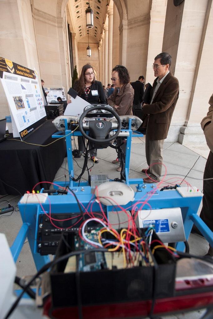 Senior Salima Fenaoui explains her engineering project at the 2015 School of Engineering Capstone Design Expo. She and her teammates designed a troubleshooting prototype for technicians to learn the ins and outs of automobile object detection systems. Photo by Lindy Rodman, University Marketing.