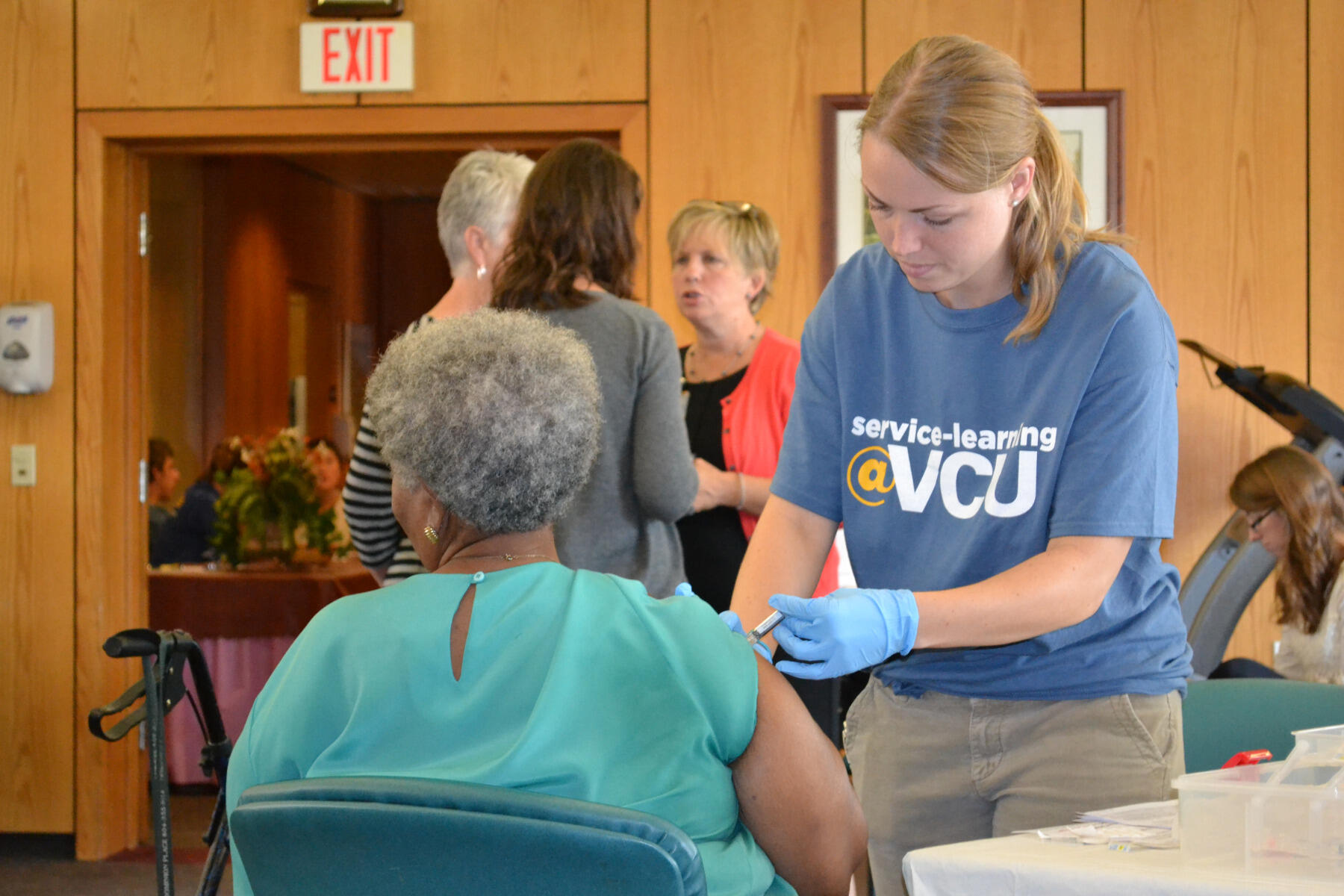 A student in the Richmond Health and Wellness Program provides on-site care during a health fair at Dominion Place.
<br>Photo courtesy of Richmond Health and Wellness Program.