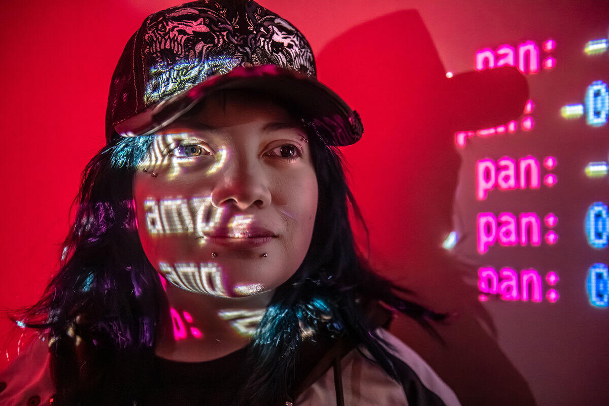 A photo of a woman with a projection of text over her face 