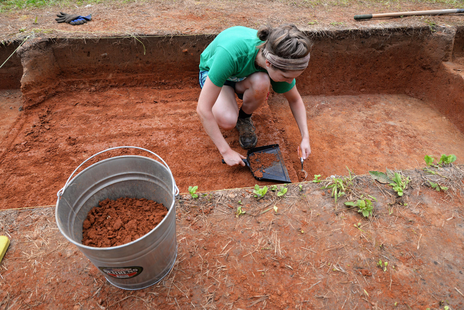Zoe Rahsman, a VCU anthropology major who graduated in December, excavates a section of the property's field.