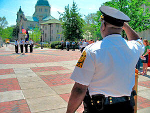 VCU Police Chief Willie B. Fuller salutes the VCUPD Honor Guard at a ceremony on VCU's Shafer Court.