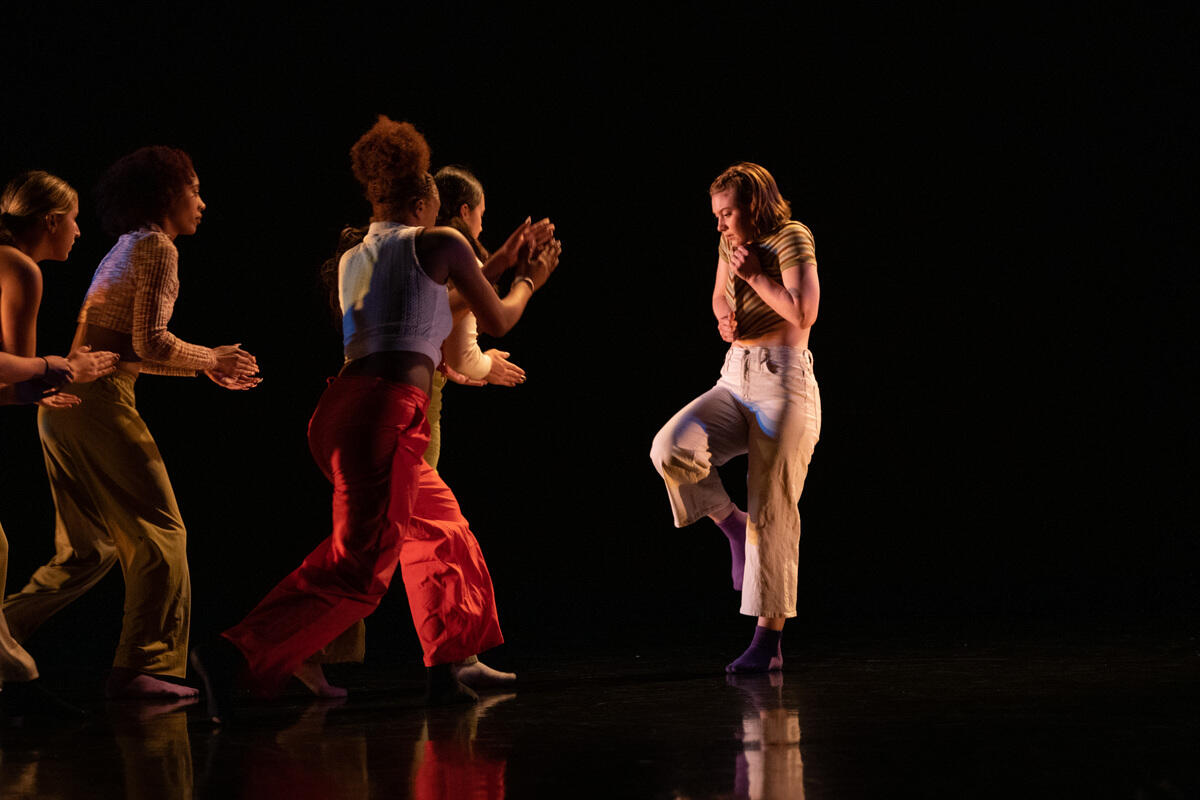Contemporary dancers perform on stage.