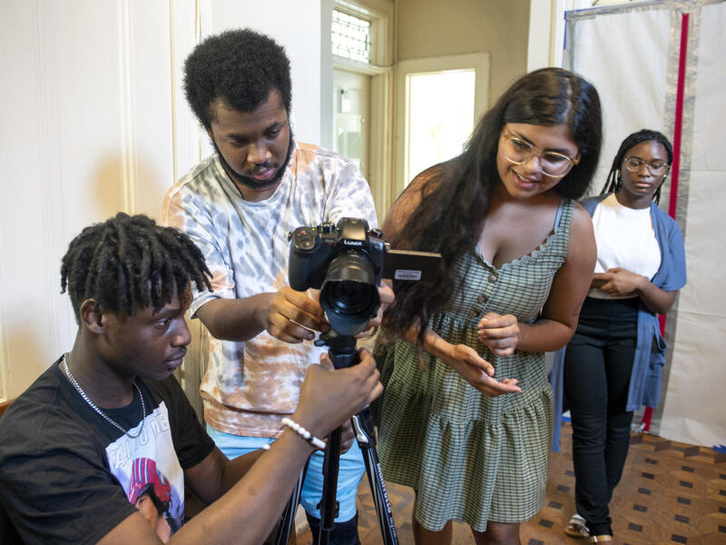 Film camp participants Bradley Baawuah, James Dew Hall and Leanna Morris prepare to film a scene under the instruction of VCU School of the Arts graduate student Manavi Singh (center) at VCU. (Photo by Kevin Morley, University Marketing)
