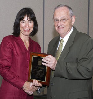 Betty Reppert, associate director of University Student Health Services, accepts the Pride Ambassador Award from VCU President Eugene P. Trani on behalf of Leah B. Czarnecki. Czarnecki, who was honored this year as the Pride Ambassador representing the VCU community, was unable to attend the ceremony. Photo by Melissa Gordon, VCU Communications and Public Relations
