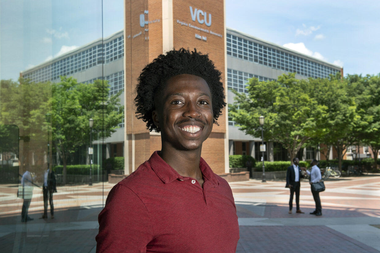 VCU student Gideon Boakye standing in front of Hibbs Hall on the Monroe Park Campus.