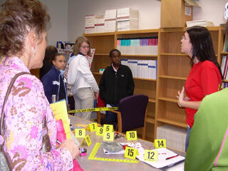 Briana Blinn, senior, Forensic Science, helped the girls investigate a crime scene and explained the many career options in the field. Photo by Anna Goroncy