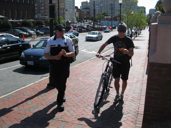 Officer Matt Ruland reminds a VCU student of bike-safety tips during a previous outreach effort. Ruland will be stationed at several intersections this week providing information on bike and pedestrian safety. 