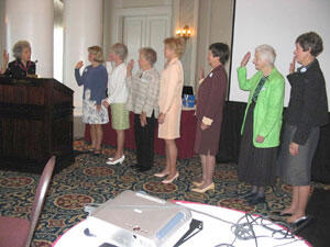 MCV Hospitals Auxiliary past President Judy Jones (left) leads the installation ceremony for Auxiliary officers for the next 12 months. Karen Shudtz, Jo Ann Burton, Charlotte Roberts, Judy Brush, Nancy Pendergast, Barbara Walser, and Julia Poppell all promised to care, commit and share on behalf of patients, families and staff at the hospital.

Photo by Michael Ford, University News Services