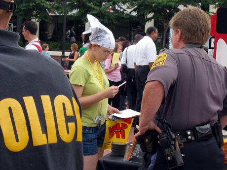 VCU Freshman Amanda Hill (center) picks up information from the VCU Police display booth at the BYOB (Bring Your Own Batteries) interactive safety and preparedness fair.  Hill visited several of the booths.  "They have a lot of information that people need," Hill said.  Photo by Mike Porter/University News Services