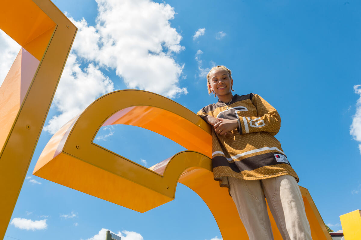  Eden Pannell leaning against a giant letter \"C\"