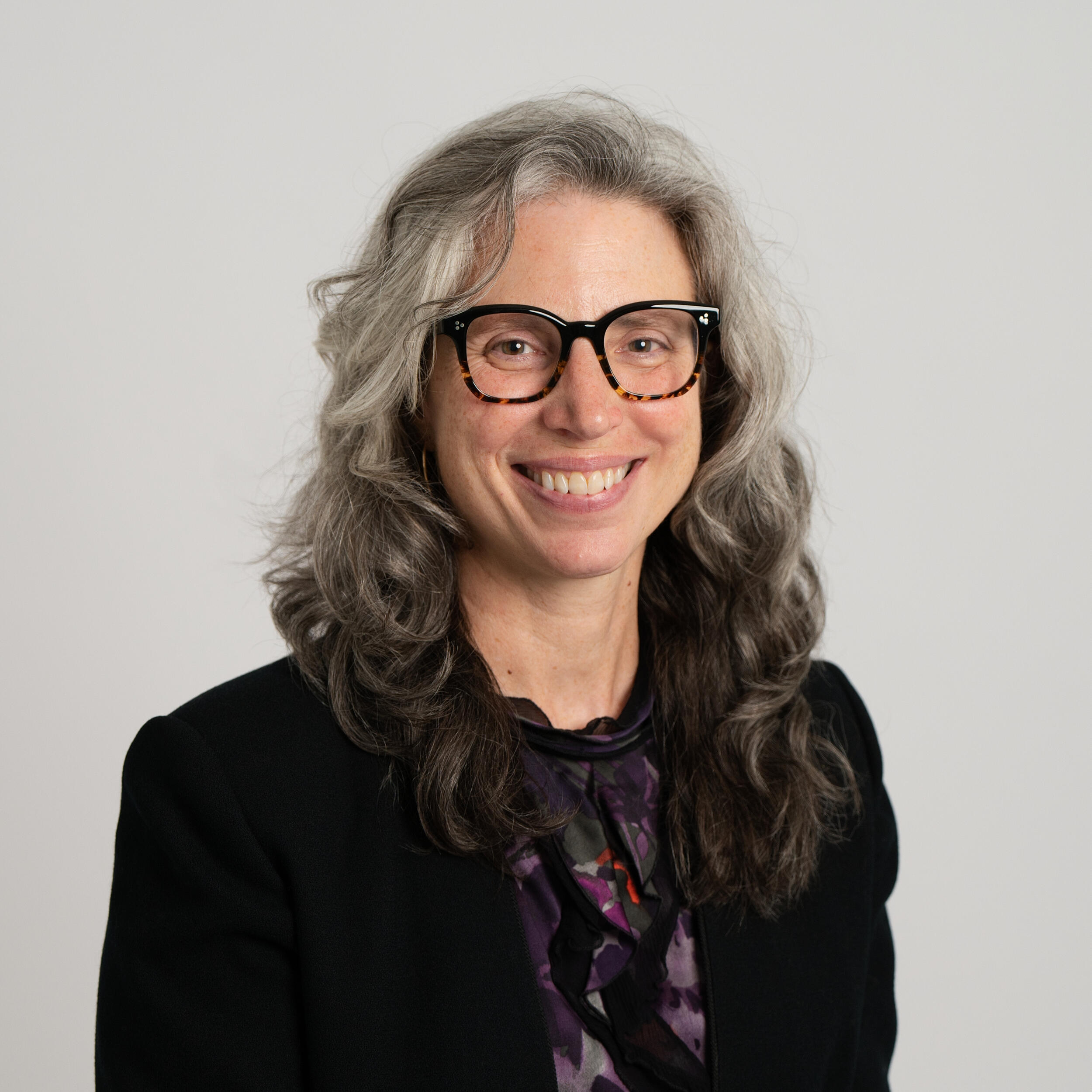 A photo of a woman from the chest up. 