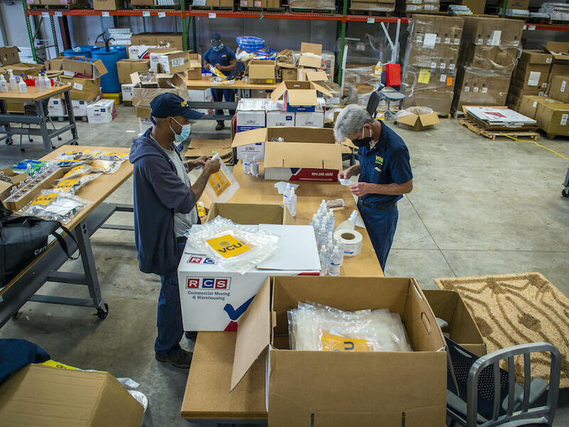 At the beginning of the pandemic, the facilities management team created an assembly line in the department’s warehouse to bottle, label and put together 7,000 personal protective equipment supply kits. (Kevin Morley, University Marketing)