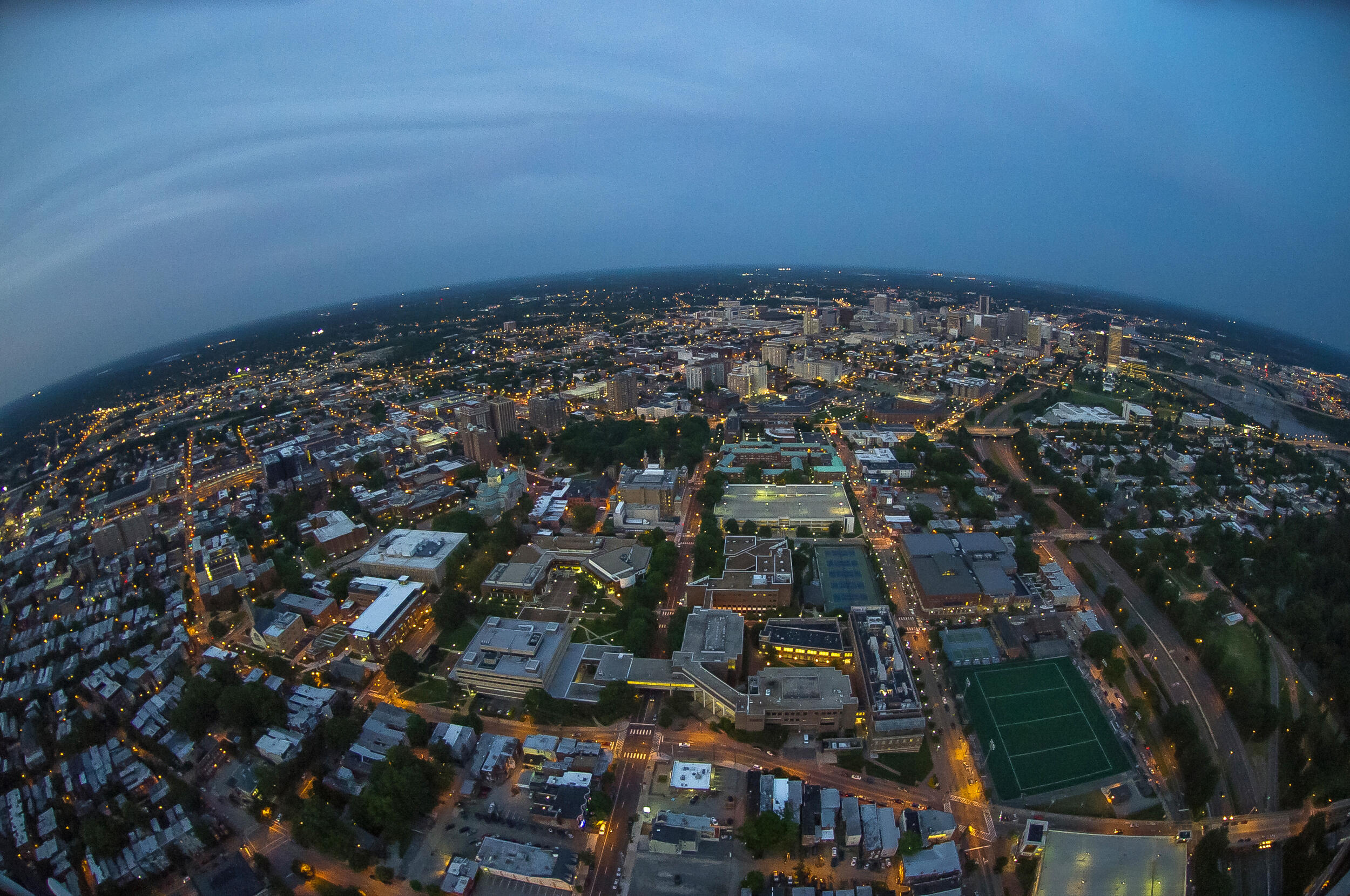 An Arial view of the city of Richmond at dusk, with a dark sky and the city street lights on 