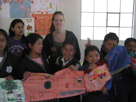 VCU undergraduate and graduate students joined their instructor and a recent graduate in art and theater education for a spring break service-learning experience in Guatemala. Through their three credit course titled “Art and Transformation: The Mayan Arts Program,” the class mixed arts based service-learning with art-making.  Students created art lessons for their Guatemalan community school partner and prepared for it through readings and discussions that focused on service, arts education, multiculturalism and social justice. In this photo, Community Engagement Service Learning Teaching Assistant April Shorter, center, is surrounded by local fifth and sixth grade students, who are showing off their artwork. Photo provided by Jan Johnston, adjunct instructor, Art Education Department.