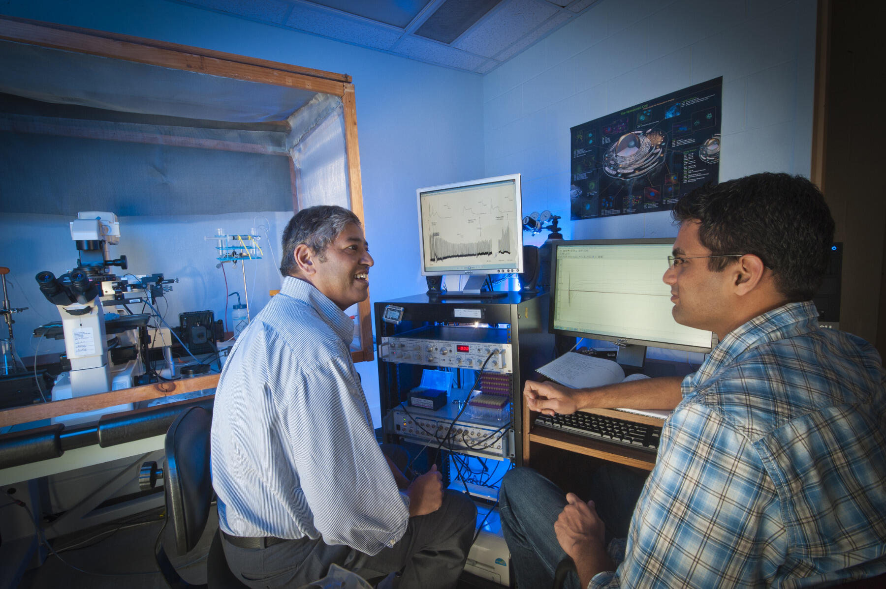 Hamid Akbarali, Ph.D. assists a graduate student in the Department of Pharmacology and Toxicology in the School of Medicine.
<br>Photo by Allen Jones, University Marketing.