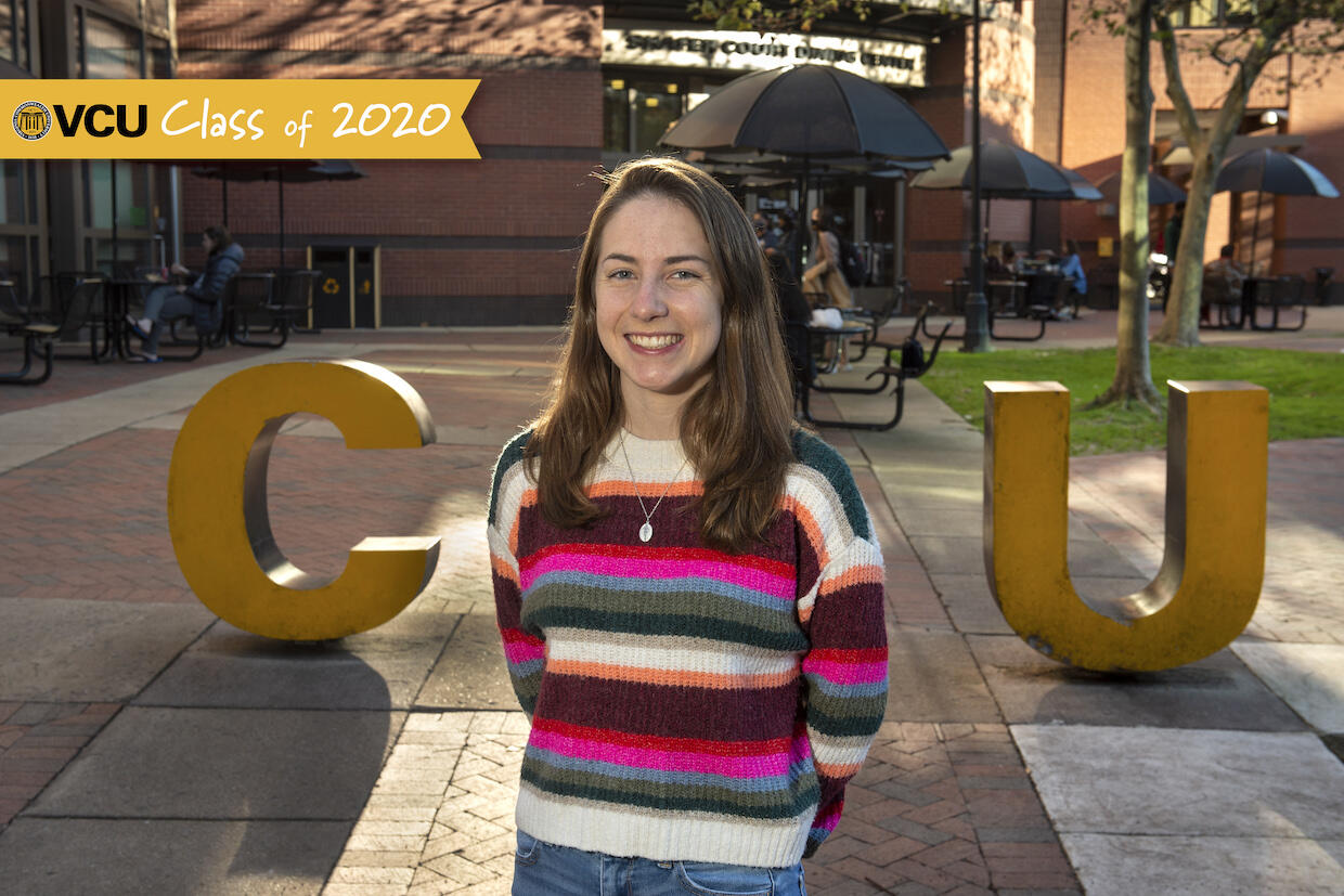 Delaney Savedge standing in front of the V C U letters next to the Shafer Court Dining Center.