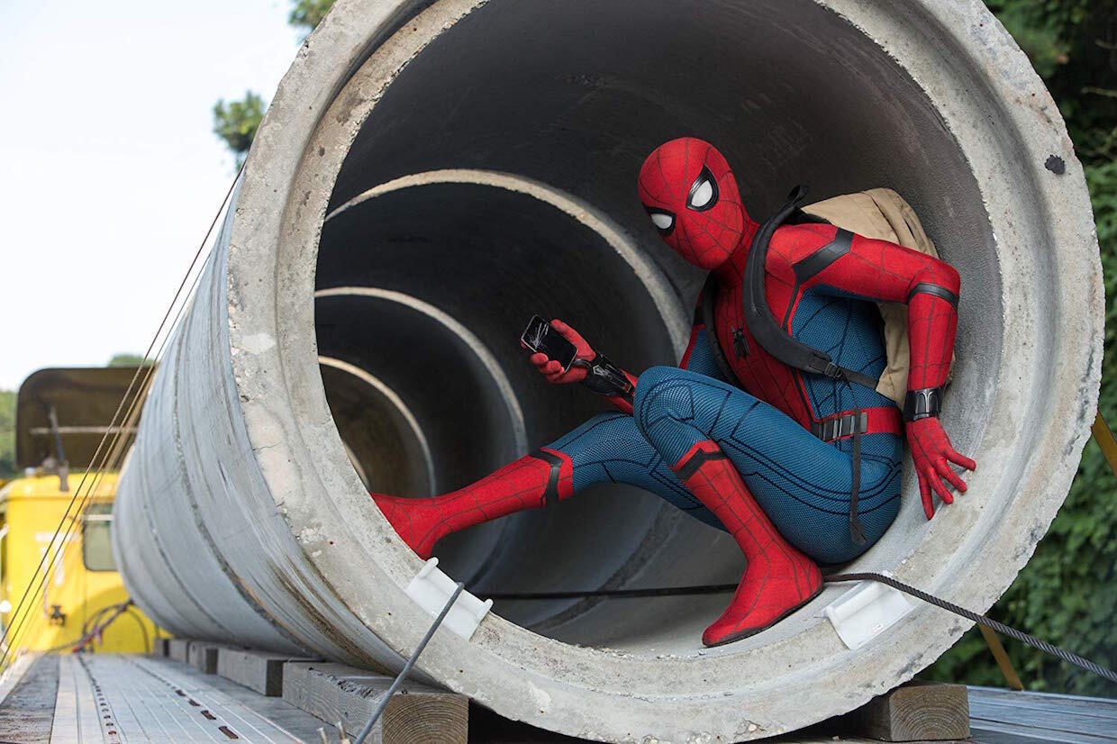 Spider-Man crouching at a construction site.