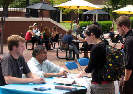 Marketing Graduate Assistant John Strickler (left) and Jayaraman Vijayakumar, associate professor, Department of Accounting, School of Business, discuss opportunities for studying abroad with mass communications student Casey Marks. The VCU Study Abroad Fair was held on Sept. 19 in the Student Commons Plaza. Students picked up information about all the options for international learning and spoke with others who recently studied abroad. Photo by Mike Porter, VCU Office of University News Services.