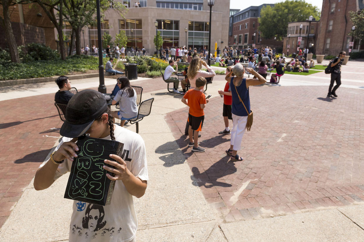 Hundreds of students gather on the Compass and nearby pedestrian walkways for the August 2017 solar eclipse.