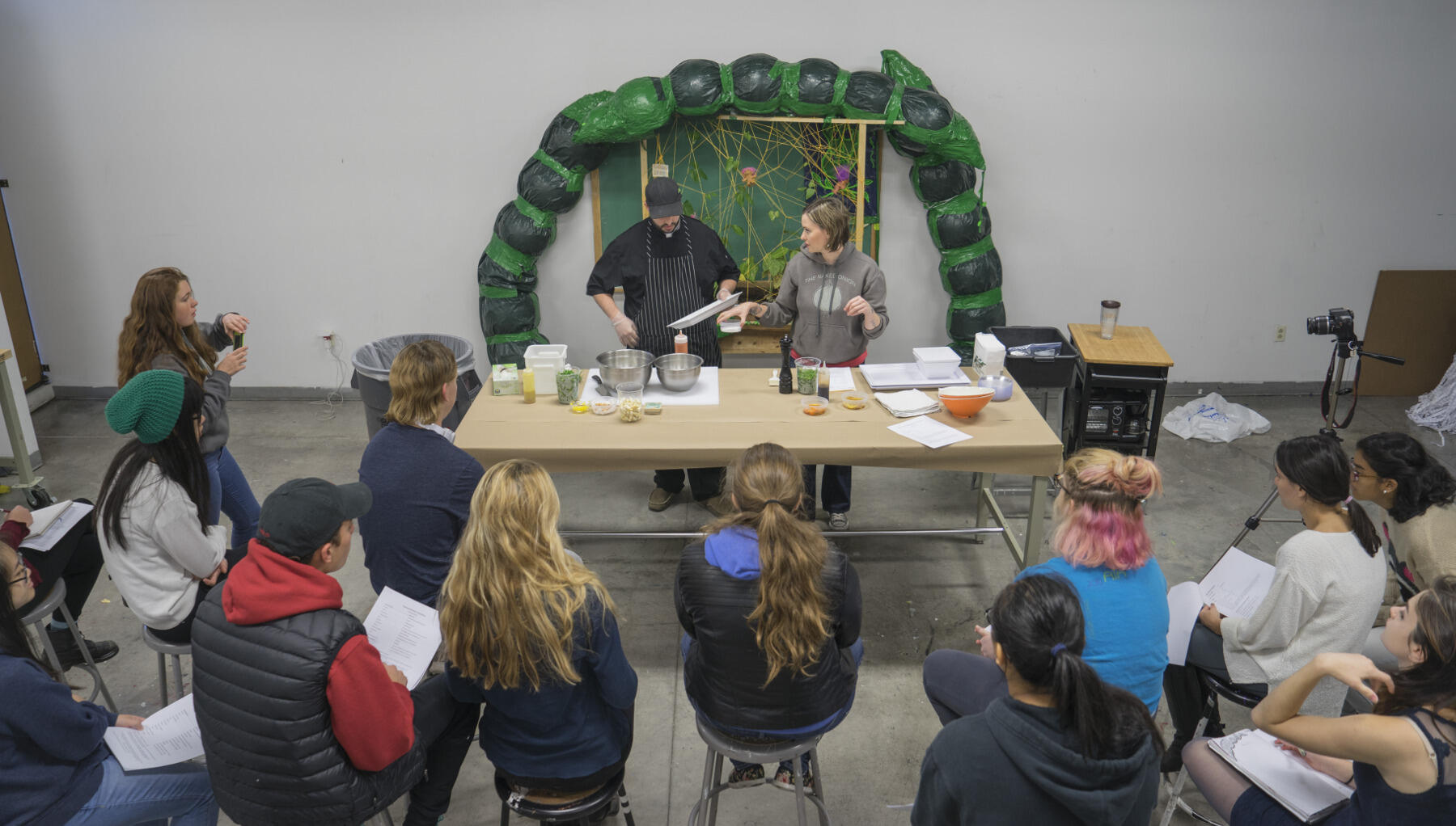 Greg Comstock and Lauren Jurk from The Naked Onion demonstrate the art of food preparation for arts students.