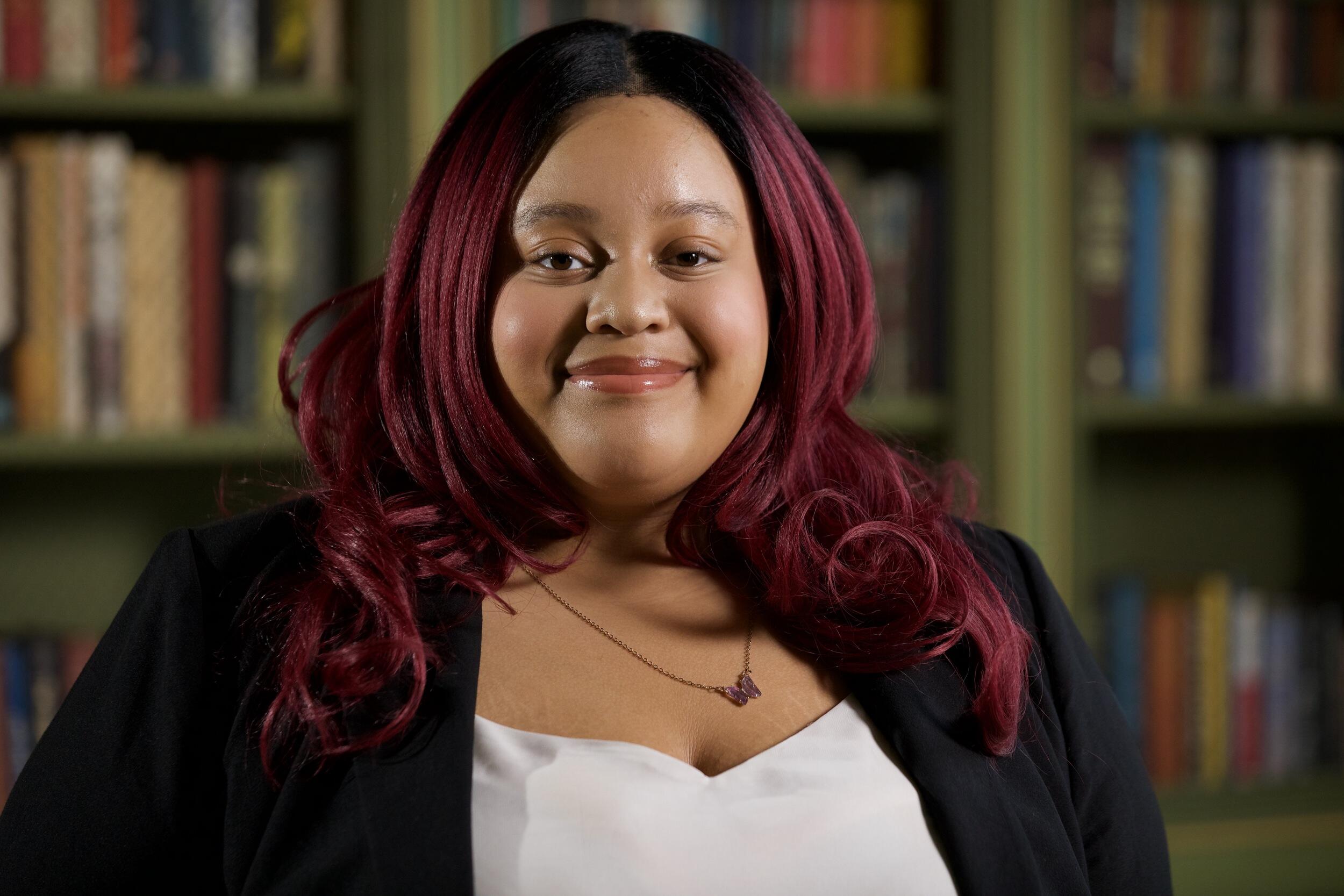 A portrait of a woman smiling at the camera.