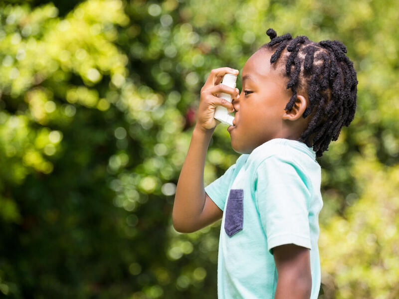 A child using an inhaler.