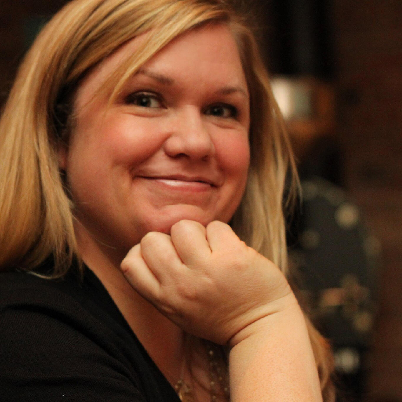 A photo of a woman from the shouldeers up. 