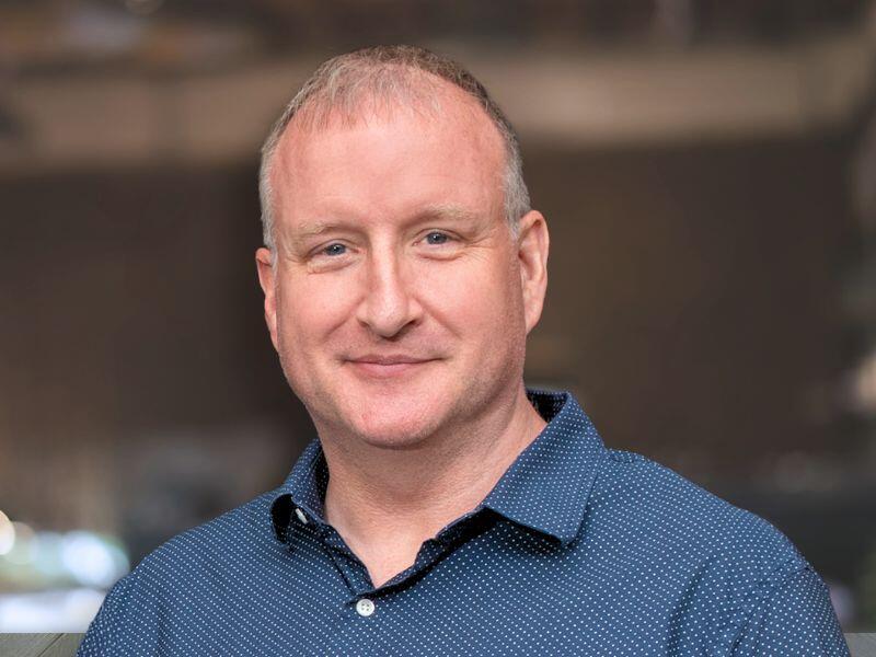 A photo of a man from the shoulders up. 