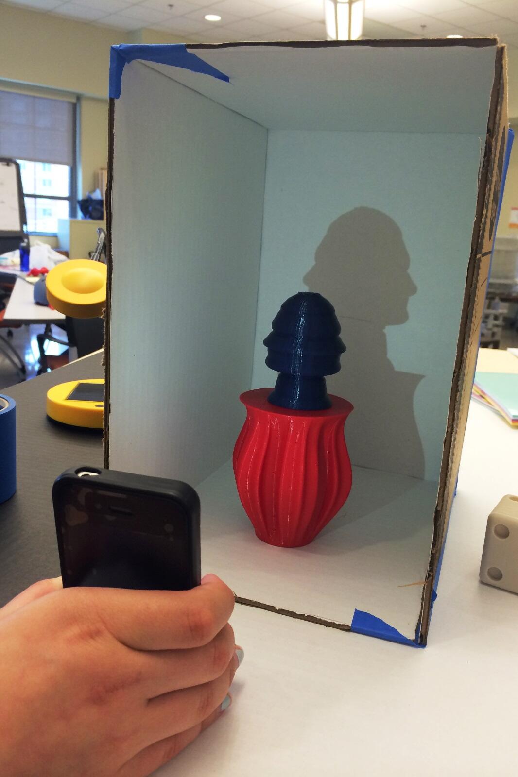 Kristina Hendel shines a light on a 3-D-printed object based on the contours of Thomas Jefferson's profile on the nickel. Hendel's team is exploring the business opportunities of offering similar 3-D objects that capture the likenesses of children or grandchildren. 