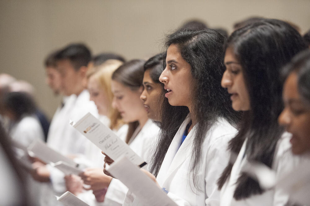 Reciting the Hippocratic Oath at the white coat ceremony was a deeply moving moment, Kraus and Lanyi said. “I became a little emotional and inspired saying the oath alongside so many other physicians in the room that have devoted their lives to medicine, including my father,” Kraus said. (Photo by Tom Kojcsich, University Relations)