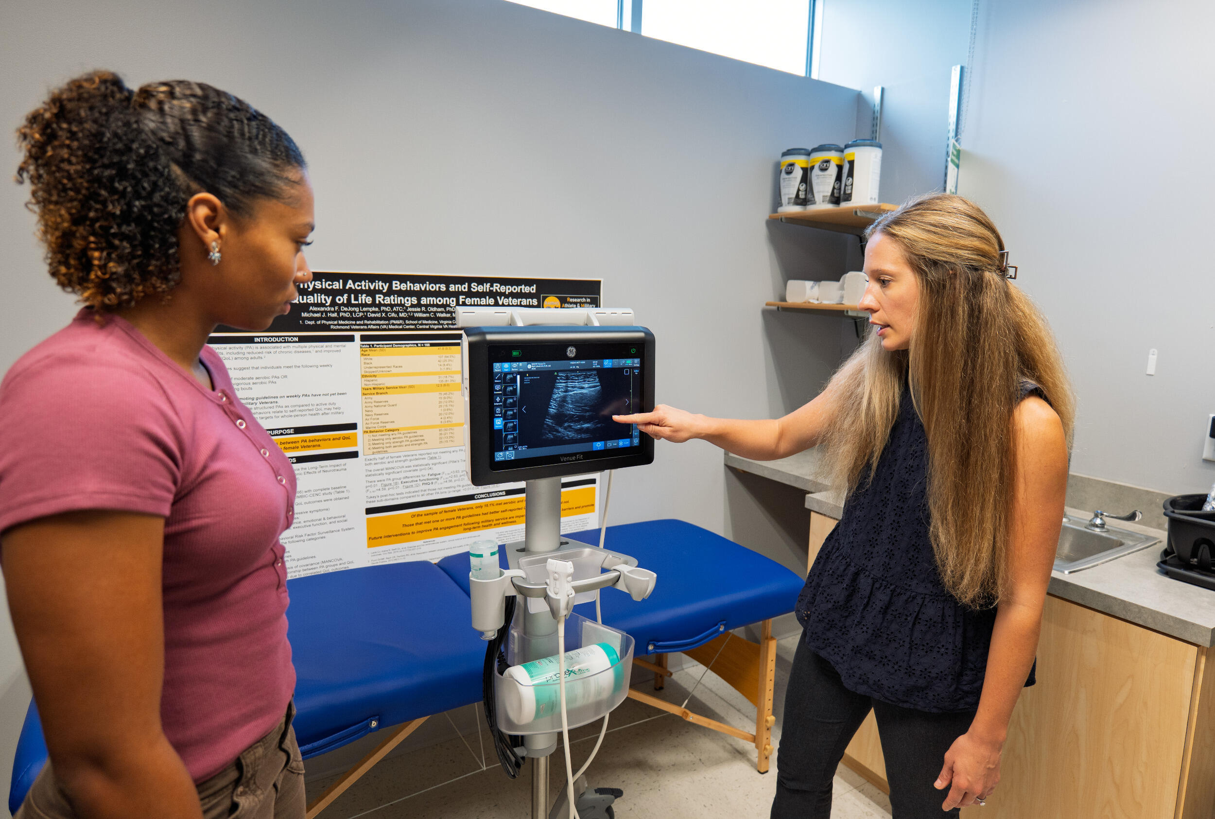 Two women study an ultrasound reading.