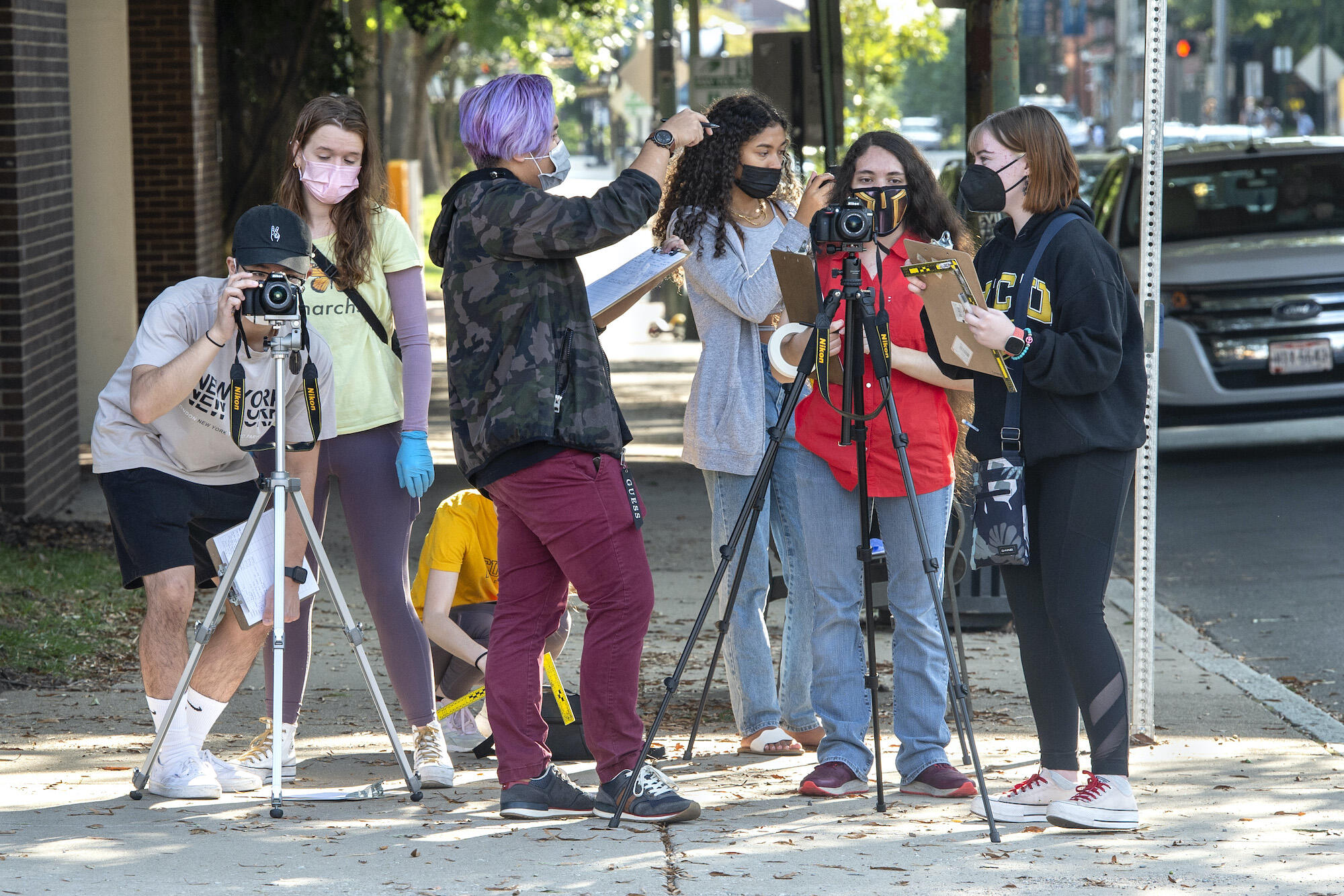 VCU students in a forensic science class stand on a street corner