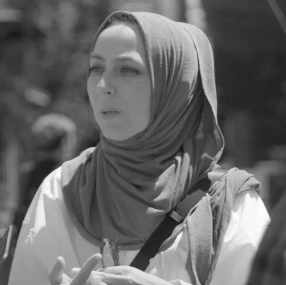 A photo of a woman from the shoulders up. 