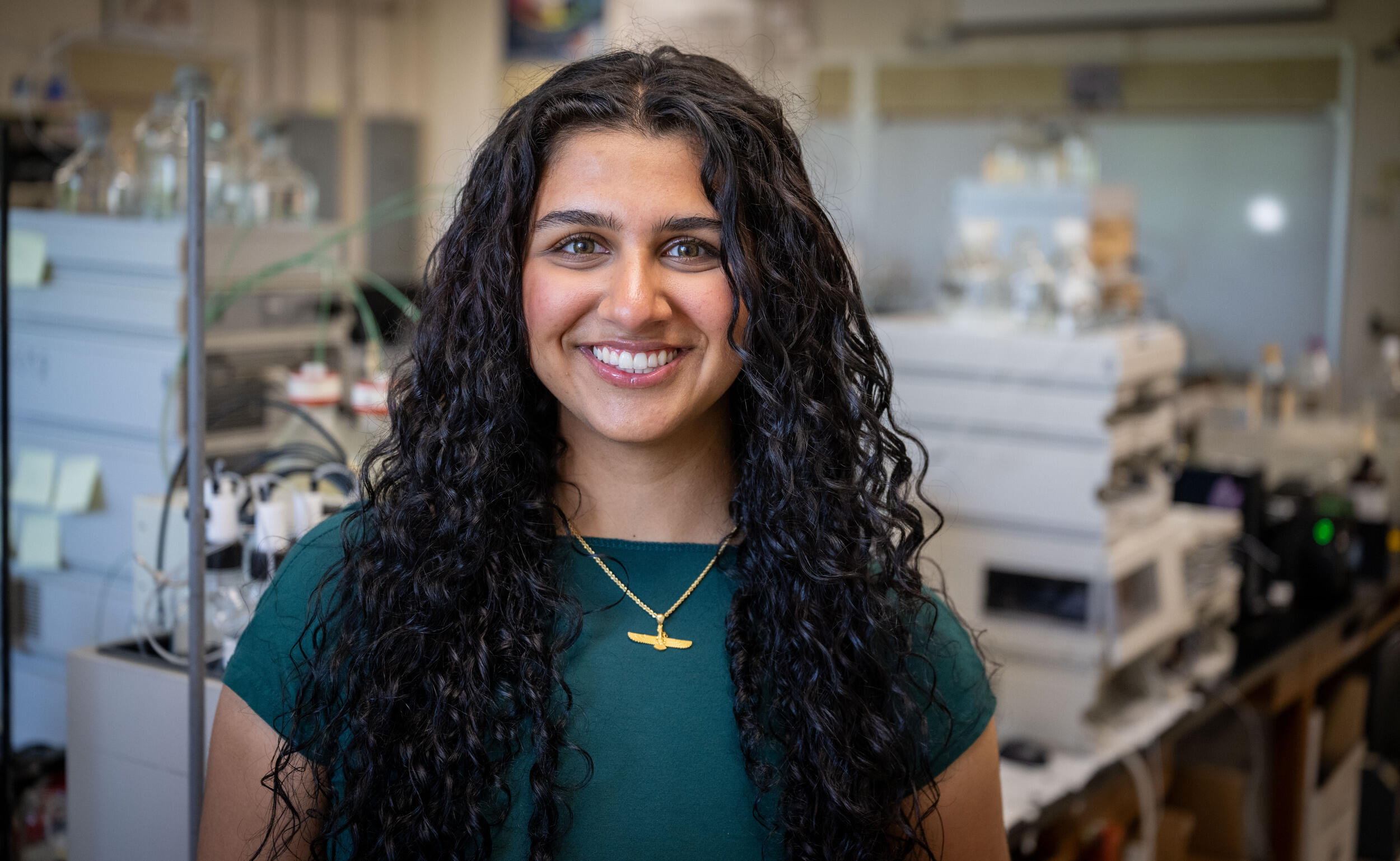 A photo of a woman standing in a science lab. 