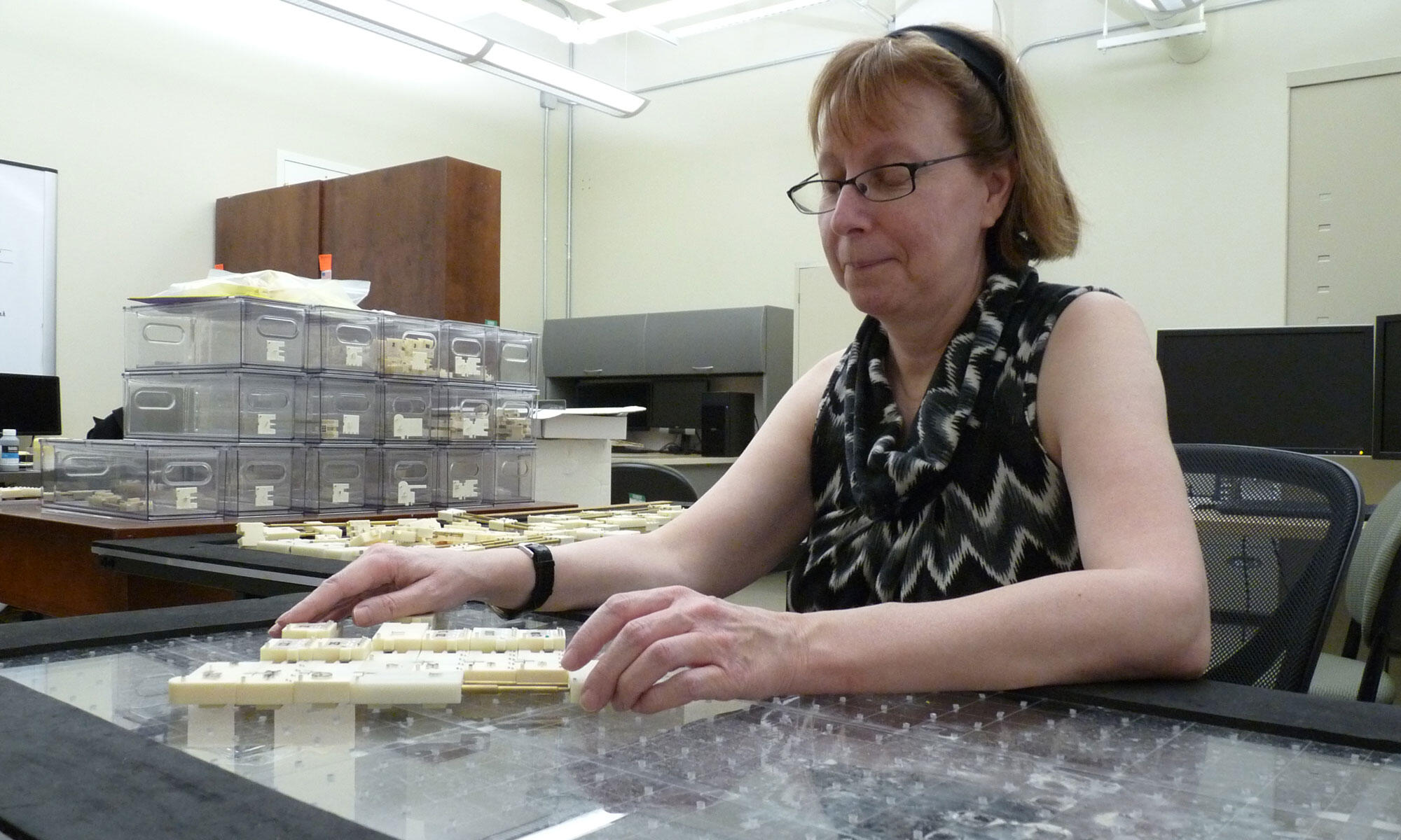 A photo of a woman sitting at a table. 