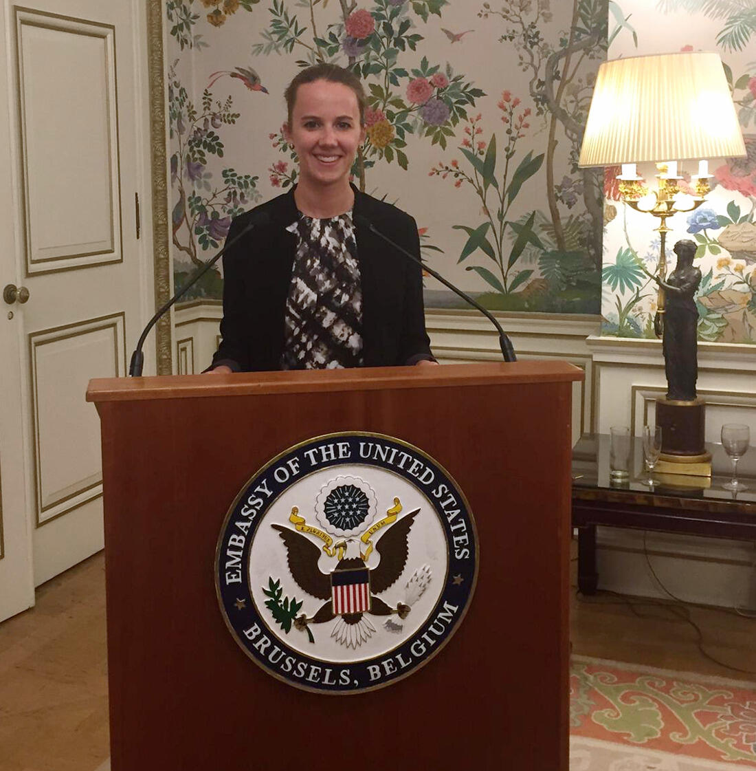 Sarah Carrier tries out the podium at the U.S. Embassy in Brussels.