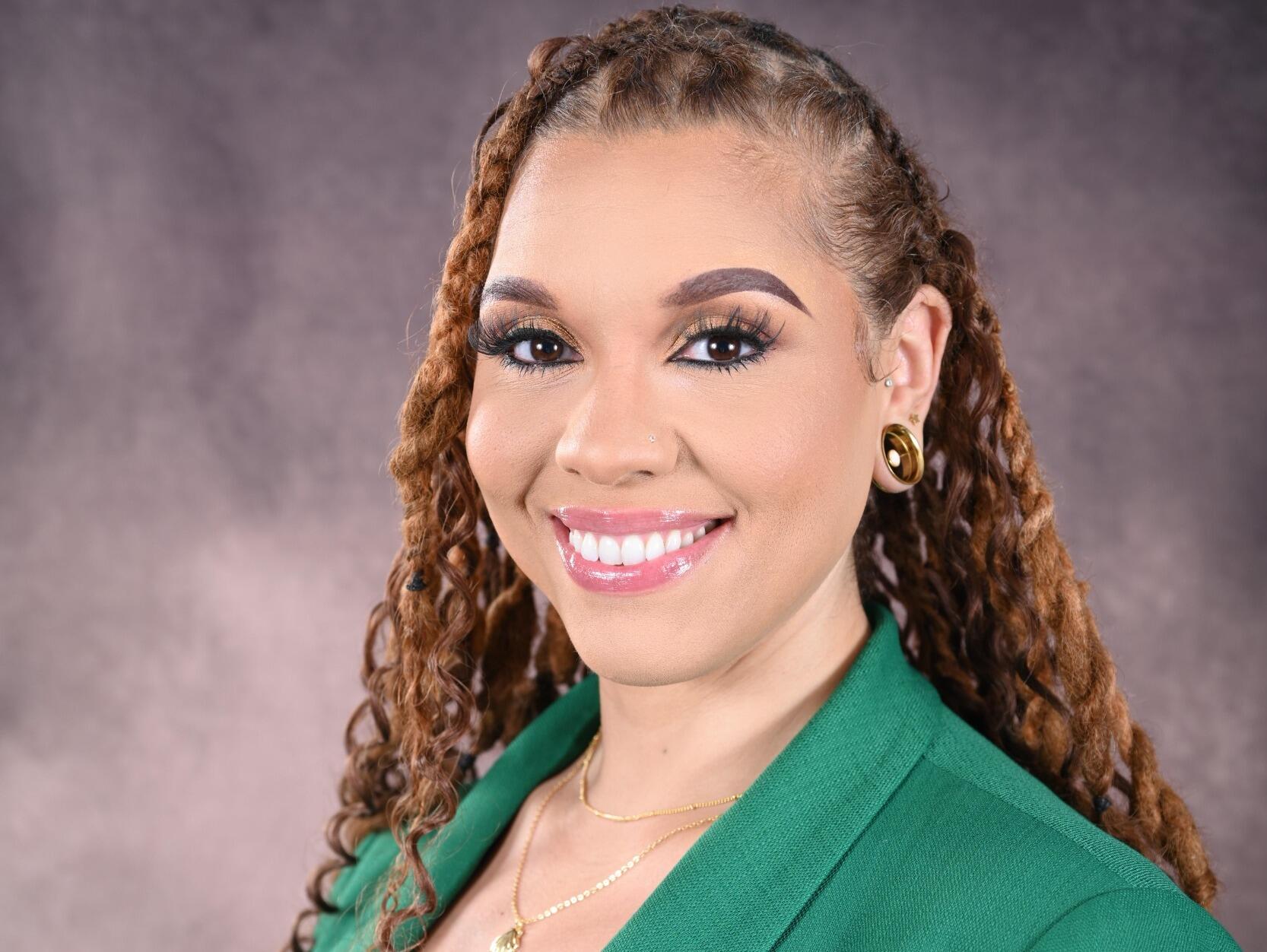 A photo of a woman from the shoulders up. 