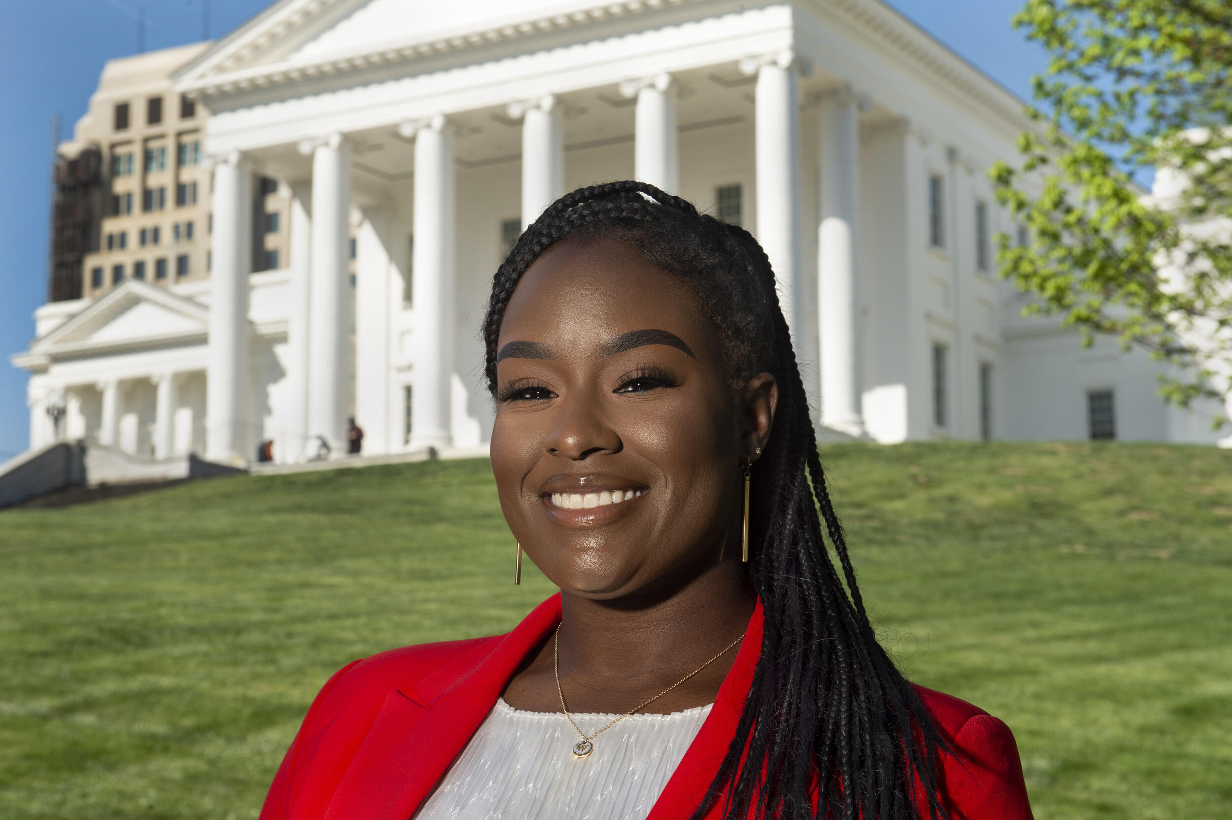 Whitney Brown smiling standing in front of the Virginia State Capitol 