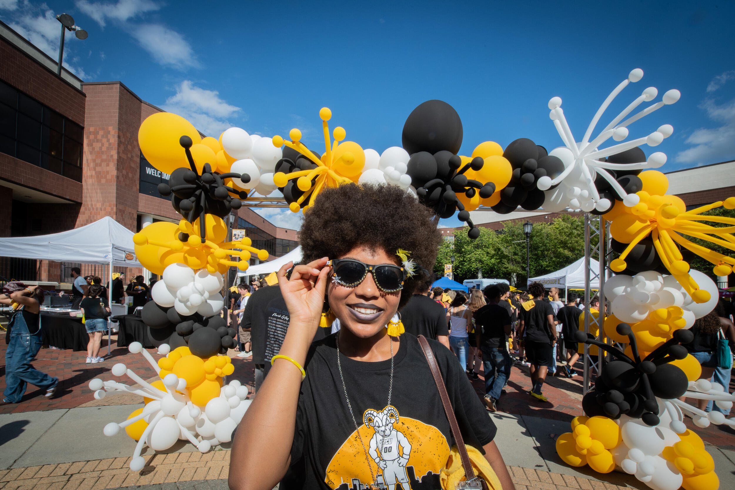 A woman in sunglasses smiles.