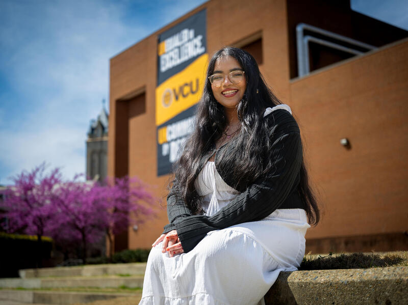 A photo of a woman sitting outside. 