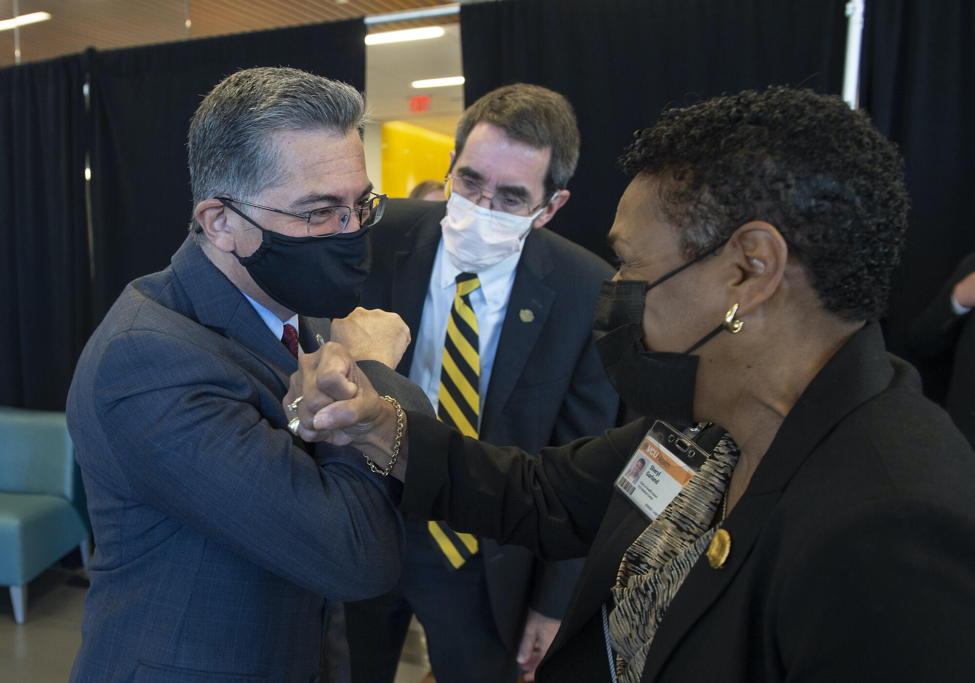 U.S. Secretary of Health and Human Services Xavier Becerra greets Sheryl Garland, chief of health impact for VCU Health System.