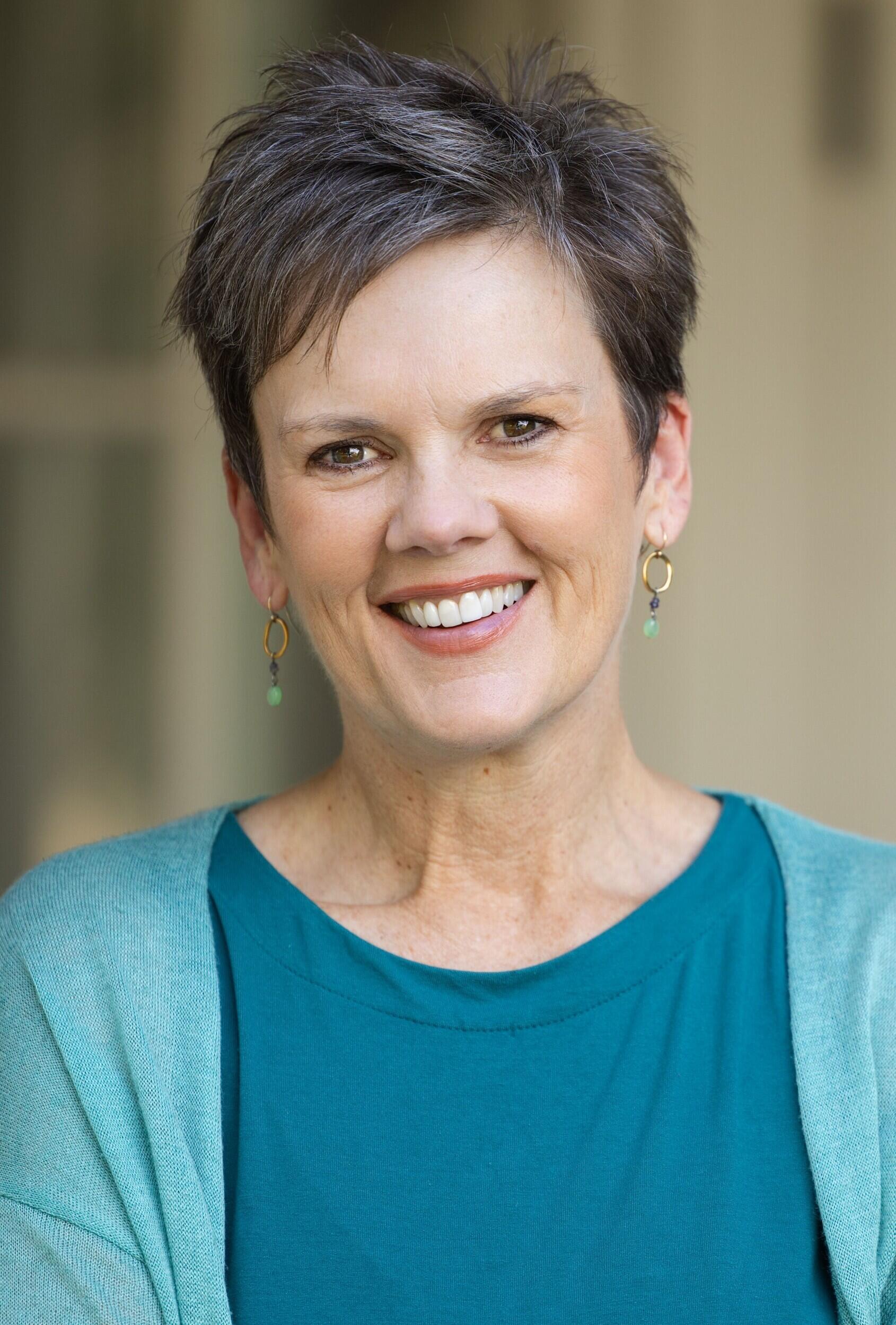 A photo of a woman from the chest up. 