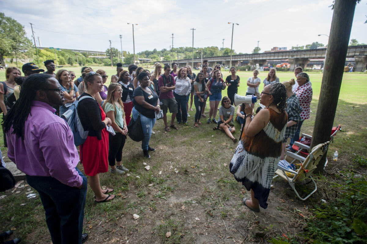  Lille A. Estes, a community strategist, talks with VCU School of Social Work students at the slave burial grounds in Shockoe Bottom as part of the Richmond [Re]Visited tour.